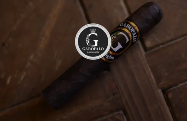 Garofalo La Famiglia Connecticut premium cigar elegantly placed on a rustic wooden surface, showcasing its sophisticated dark wrapper and distinctively detailed cigar band, evoking luxury and rich flavor crafted for cigar enthusiasts.