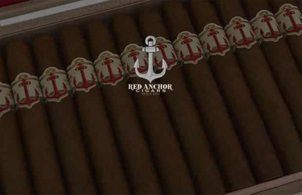 "Red Anchor premium cigars neatly arranged in a wooden cigar box, prominently featuring their distinctive white and red cigar bands with anchor motifs, reflecting their rich heritage and dedication to quality since 1772.