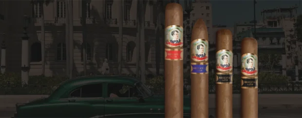 Lineup of Byron Reserva cigars from the 20th Century collection, labeled 3, 4, and 5 Años, showcased in front of a vintage Cuban street scene with a classic green car and colonial architecture.